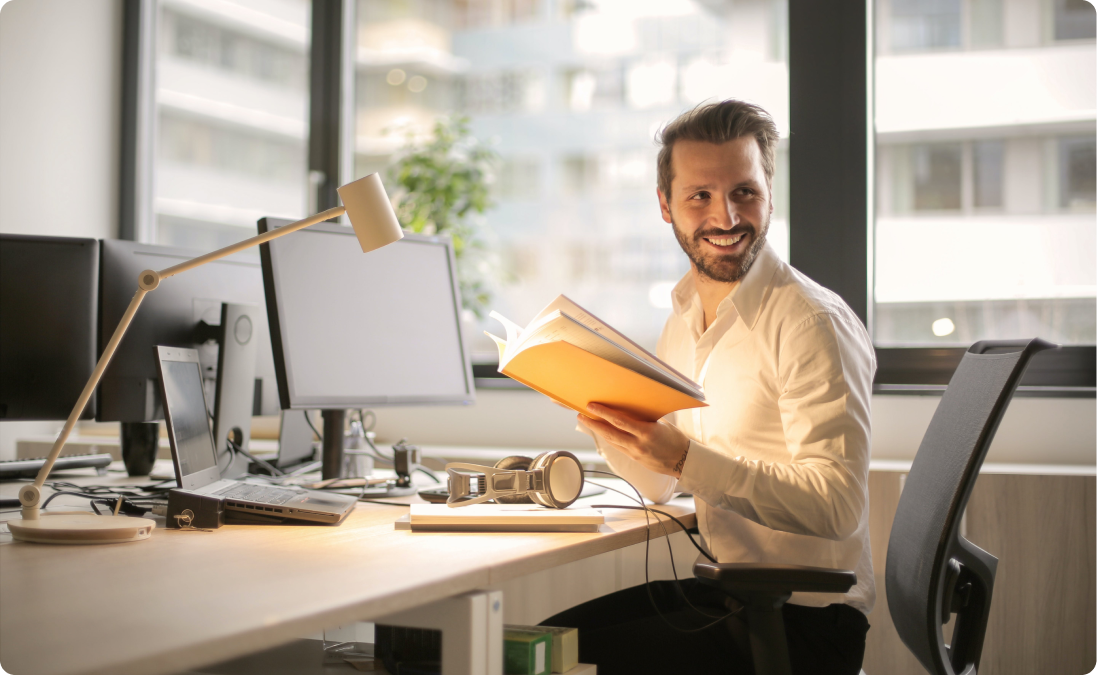 A man sitting at a desk representing native Portuguese translators working at a Portuguese translation agency.