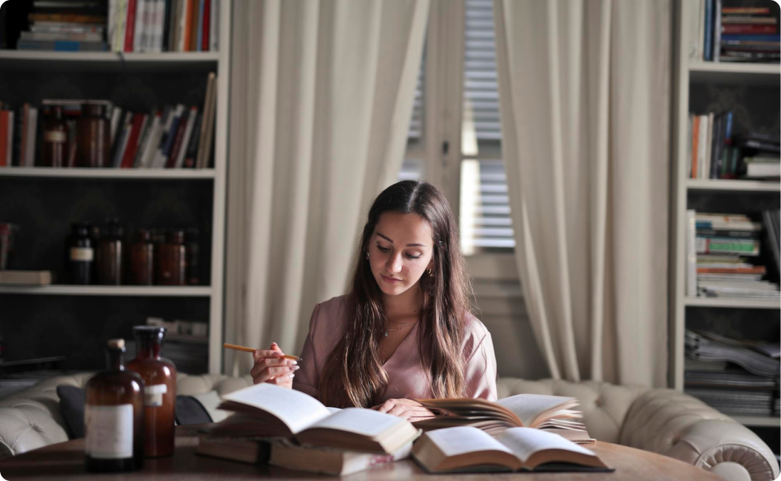 A woman looking at a European Portuguese dictionary for her Portuguese translation project.